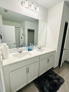 Beautiful Brand new 3bedroom home في بورت سانت لوسي: حمام به مغسلتين ومرآة كبيرة