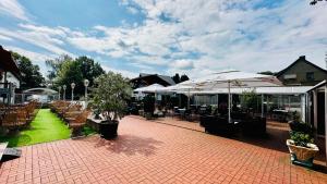 a patio with tables and chairs and umbrellas at Georgenberg in Spremberg