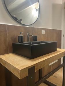 a bathroom with a black sink and a mirror at Dimora Apulia 5 in Gallipoli +29 photos