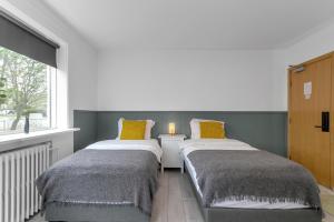 Postel nebo postele na pokoji v ubytování Flóki by Guesthouse Reykjavík