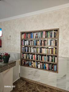 a book shelf filled with books in a room at Julia's apartment in Marbella