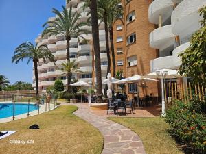 a resort with a swimming pool and a hotel at Julia's apartment in Marbella