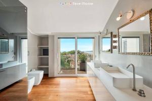 a bathroom with two sinks and a large window at Bay View Home, TerreMarine in La Spezia