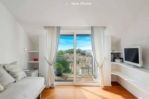 a living room with a large window with a view at Bay View Home, TerreMarine in La Spezia