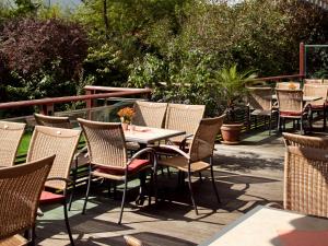 a group of tables and chairs on a patio at Hotel Bayerischer Hof in Bad Füssing
