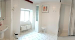 a white bathroom with a shower and a sink at Residenz Mosel-Trip in Senheim +9 photos