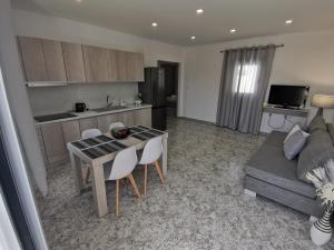 a kitchen and living room with a table and a couch at Venus De Milo in Adamas