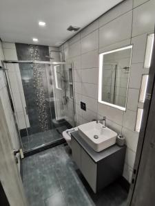 a bathroom with a sink and a shower at Venus De Milo in Adamas