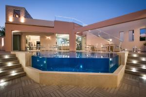 a house with a swimming pool in front of it at Omiros Boutique Hotel (Adults Only) in Rethymno