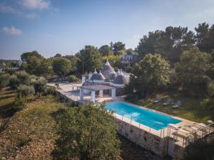 an aerial view of a house with a swimming pool at HELLO APULIA, Trulli Santa Maria dei Grani - with private pool and large garden for furry friends in Ceglie Messapica