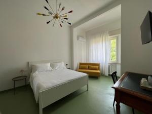 a bedroom with a bed and a chair and a table at Civico 99 in Ravenna
