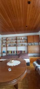 a bedroom with a table and bookshelves at Haus Am Teich Oetjens in Weilburg_Gaudernbach