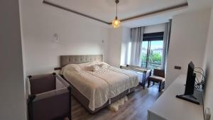 a bedroom with a bed and a large window at Уютная вилла в Чамьюва in Kemer +19 photos
