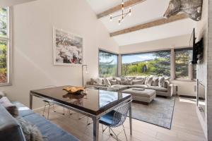 a living room with a couch and a table at Snowmass Villas 3 bedroom plus loft in Snowmass Village