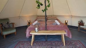a bedroom with a bed in a tent at Bell Tent in een Voedselbos in Nederweert-Eind