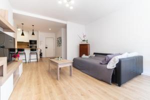 a living room with a couch and a table at Apartamento Granollers in Granollers +22 photos