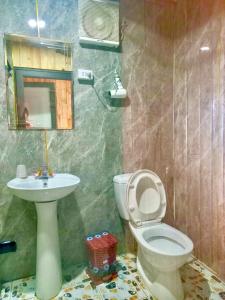 a bathroom with a toilet and a sink at VALLEY VIEW COFFEE & STAY in Sa Pa +50 photos