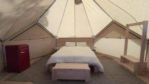 a bedroom with a bed in a tent at Camping Pla de la Torre in Sant Antoni de Calonge