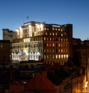 a building lit up at night in a city at The Vermont Hotel & Vermont Aparthotel in Newcastle upon Tyne