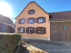 a house with a bunch of windows and a garage at La ferme de Lili in Truchtersheim