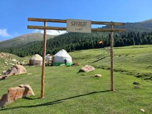 a sign in a field with tents in a field at Sayakat Eco Camp in Kaji-Say +25 photos