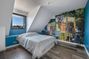 a bedroom with a bed with blue walls and a mural at Piscine - 10 personnes - 100m de la plage in Saint-Sébastien +21 photos