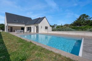 a swimming pool in front of a house at Piscine - 10 personnes - 100m de la plage in Saint-Sébastien