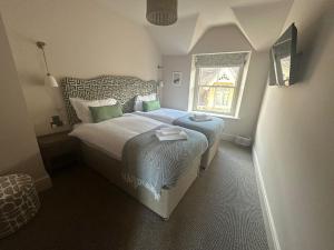 a small bedroom with a bed and a window at The Golden Cross in Cirencester