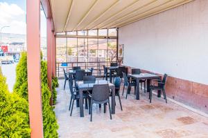 a patio with tables and chairs on a balcony at Ürgüp Elit Otel in Ürgüp +5 photos