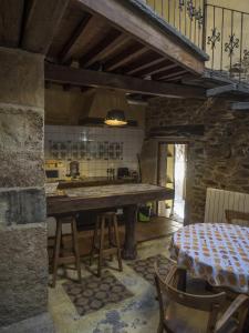 a kitchen with a large wooden table in a room at Hotel Rural Bermellar in Bermellar