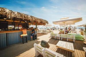 a bar on the beach with tables and chairs at Spacious Beachfront Two-Bedroom Apartment in Caesar Beach in Boghaz