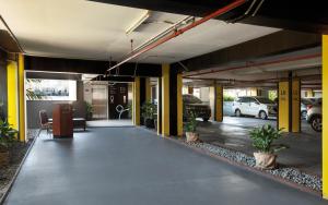 an empty parking lot with cars parked in a garage at ROOMS INC d'botanica Bandung in Bandung