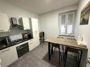a kitchen with a table and some chairs in it at Appartement in Belfort