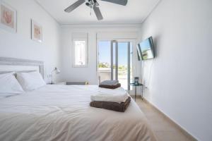 a bedroom with a large white bed with a tv on the wall at Modern 3 bedroom Town House MA14LT in Torre-Pacheco +36 photos
