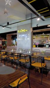 a dining room with tables and chairs in a restaurant at Rooms Inc BTC Bandung in Bandung