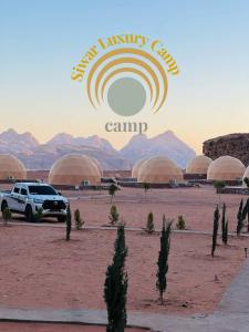 a car parked in a desert with a sign that reads main harry camps at Siwar Luxury Camp in Wadi Rum