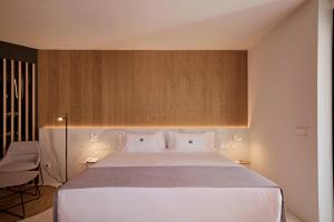 a bedroom with a large white bed with two pillows at Core Ibiza Town Hotel in Ibiza Town