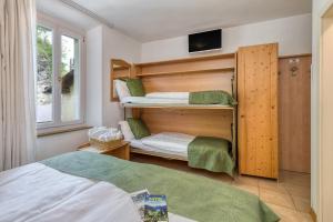 Posteľ alebo postele v izbe v ubytovaní Albergo Alla Costa