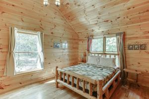 a bedroom with a bed in a log cabin at Deluxe Cabin For Groups Near Helen w Hot Tub in Cornelia