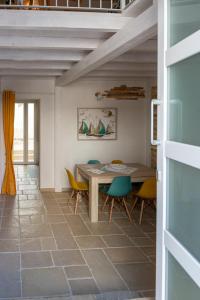 a dining room with a table and chairs at Seasons Home San Foca in San Foca