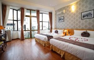 Postel nebo postele na pokoji v ubytování Hanoi Win Hotel & Travel + 37 fotografií