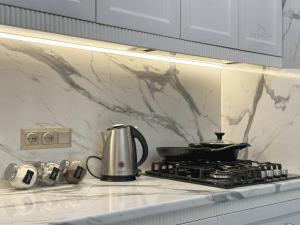 a coffee pot sitting on top of a stove in a kitchen at Boulevard Tashkent City in Tashkent