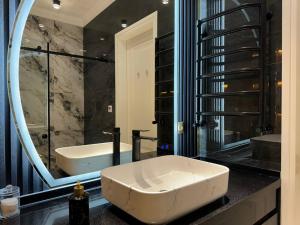 a bathroom with a tub and a sink and a mirror at Boulevard Tashkent City in Tashkent +12 photos
