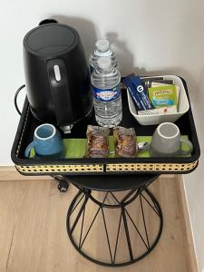 a tray with a coffee maker and drinks and food at La petite Irlande in Auderville