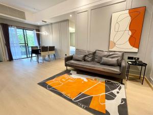 sala de estar con sofá de cuero y alfombra en Boss Mansion en Bangkok