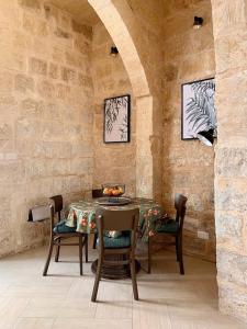 a dining room with a table and some chairs at Terrace Room on Parish Street in Luqa +3 photos