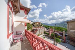 a balcony with a view of a city at Feel Discovery Villa Aura Douro Valley in São Martinho de Mouros