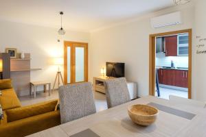 a living room with a table and a couch at Casa Formosa - Tavira in Tavira