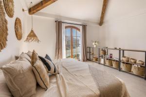 a bedroom with a bed with pillows and a window at Villa Mirador del Lago in Lecrin +30 photos