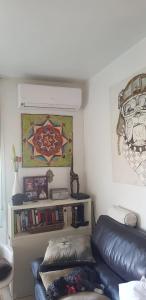 a living room with a leather couch and a book shelf at Modern Apartment in Calafell + Terrace in Calafell